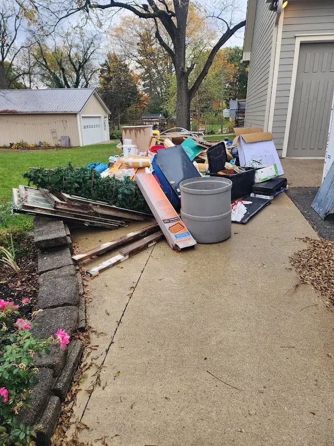 Dumpster being loaded with debris for Estate Cleanout Dumpster Rental in Cherryland